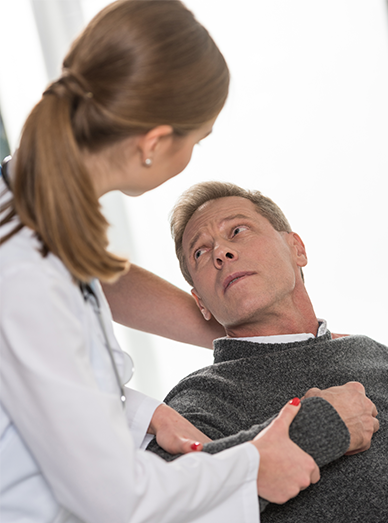 Doctor supporting an older man during a health assessment exam at Botanic Ridge Doctors